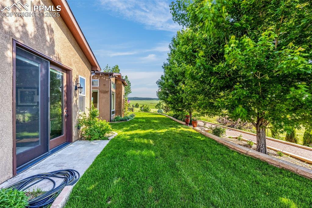11784 Spruce Mountain Road Larkspur, CO 80118 - Photo 38 of 49 a view of a house with a yard
