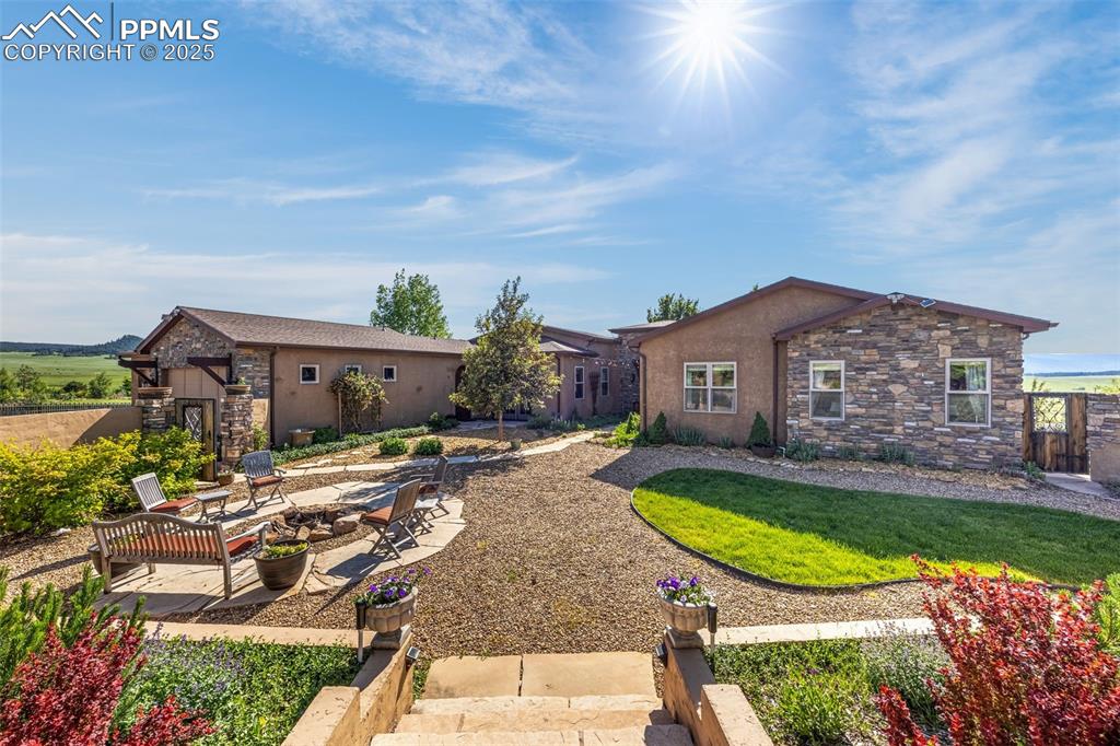 11784 Spruce Mountain Road Larkspur, CO 80118 - Photo 4 of 49 a view of a house with garden