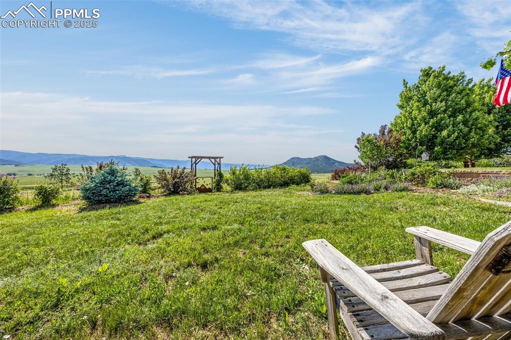 11784 Spruce Mountain Road Larkspur, CO 80118 - Photo 41 of 49 a view of a two chairs in a yard