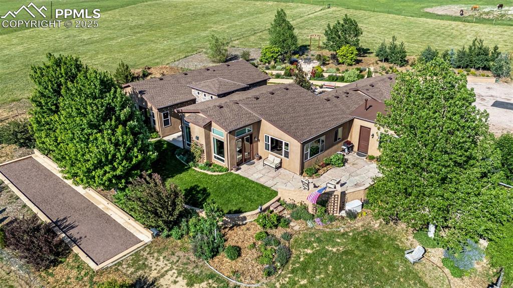 11784 Spruce Mountain Road Larkspur, CO 80118 - Photo 45 of 49 an aerial view of a house with a garden