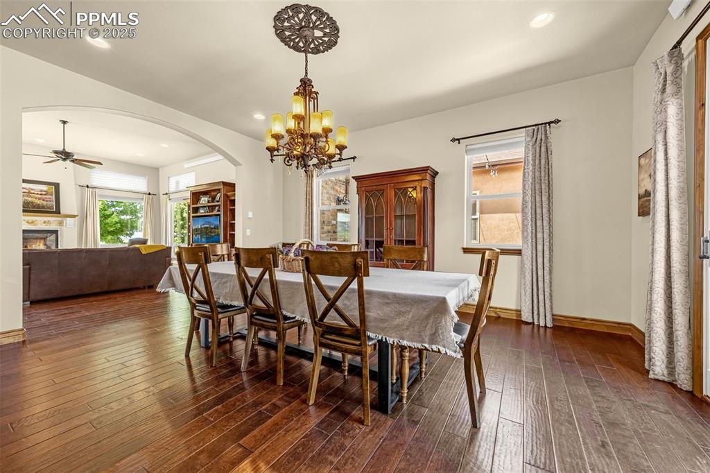 11784 Spruce Mountain Road Larkspur, CO 80118 - Photo 7 of 49 a view of a dining room with furniture and wooden floor