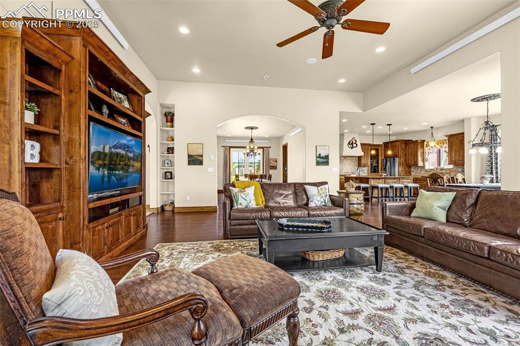11784 Spruce Mountain Road Larkspur, CO 80118 - Photo 10 of 49 a living room with fireplace furniture and a flat screen tv