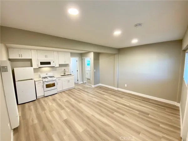 a kitchen with stainless steel appliances a white cabinets and sink
