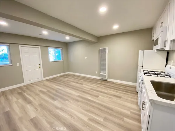 a view of a kitchen with a sink and a stove top oven