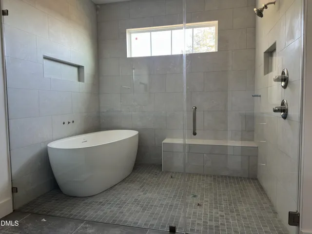 a bathroom with a bathtub and window
