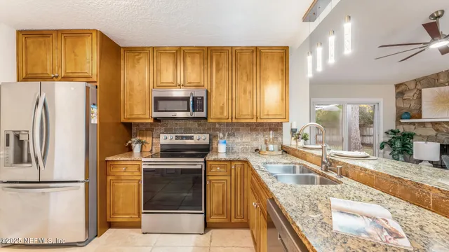 a kitchen with a refrigerator stove and sink