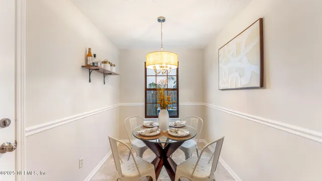 a view of a dining room with furniture and window