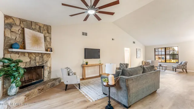 a living room with furniture and a fireplace