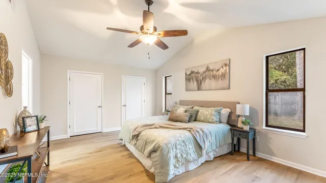 a bedroom with a bed and wooden floor
