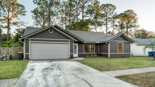 a front view of a house with a yard and garage