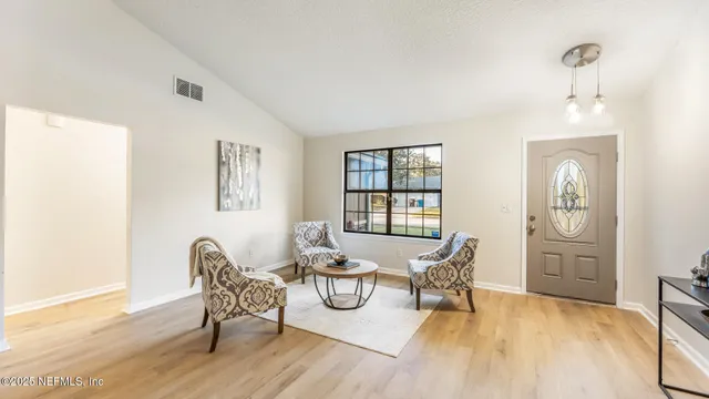 a view of a dining room with furniture and wooden floor