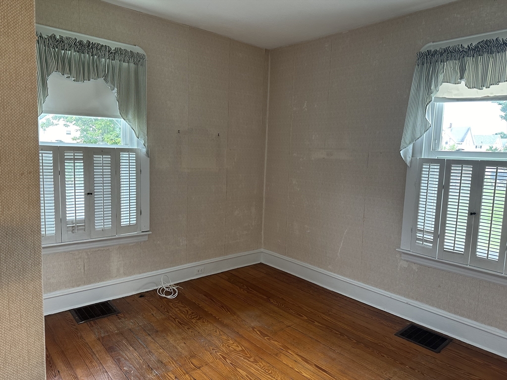 138 Anthony Street Fall River, MA 02721 - Photo 6 of 11 an empty room with wooden floor and windows