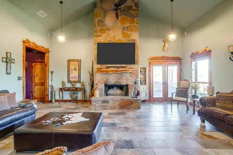 a living room with furniture a flat screen tv and a fireplace