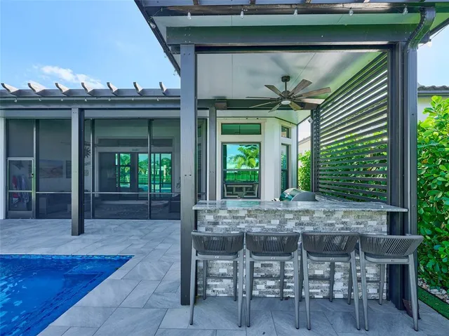 a kitchen with granite countertop a table chairs stove a refrigerator and cabinets