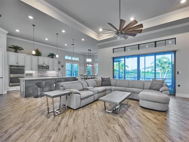 a kitchen with stainless steel appliances granite countertop a sink a stove and a wooden floors