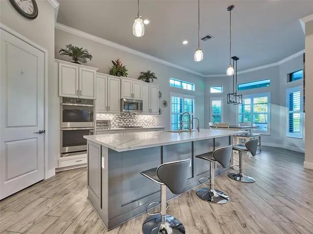 a spacious bedroom with a large bed and a chandelier