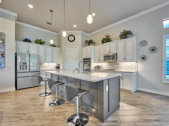 a bedroom with a large bed and a ceiling fan