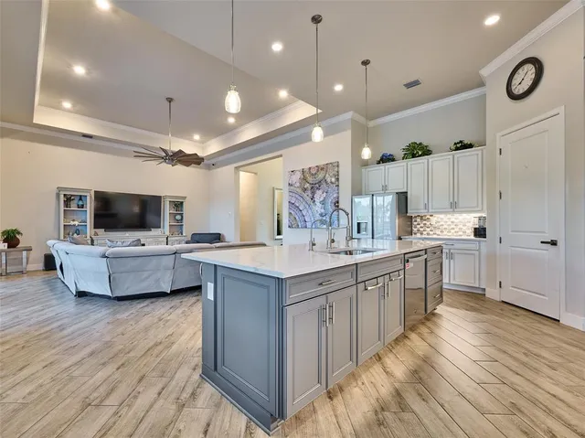 a bedroom with a bed and a flat screen tv on dresser