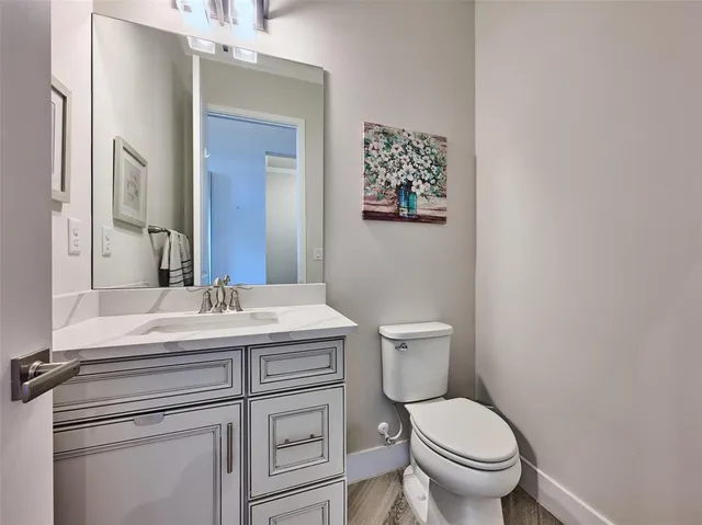 a spacious bedroom with a bed chandelier and a window