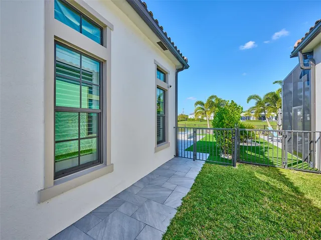 a view of a patio with table and chairs potted plants with wooden floor