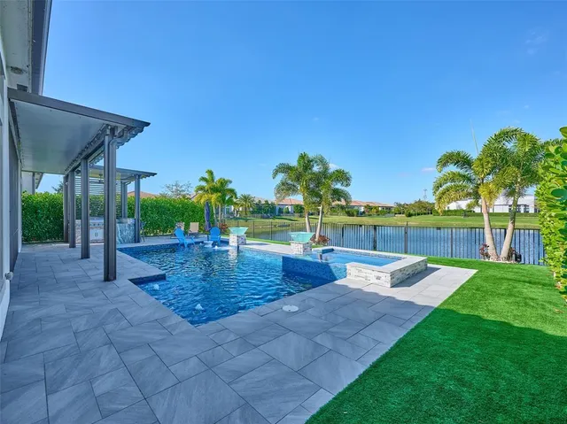 a view of a house with a yard patio and swimming pool
