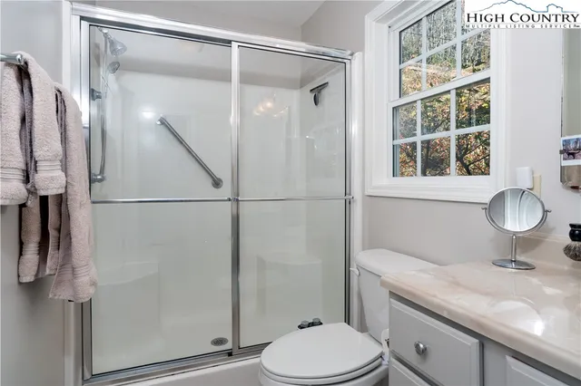 a bedroom with bed and a window