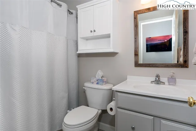 a view of a house with a yard and large tree