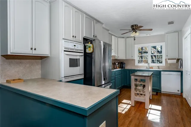 a bedroom with a bed chair and painting on the wall