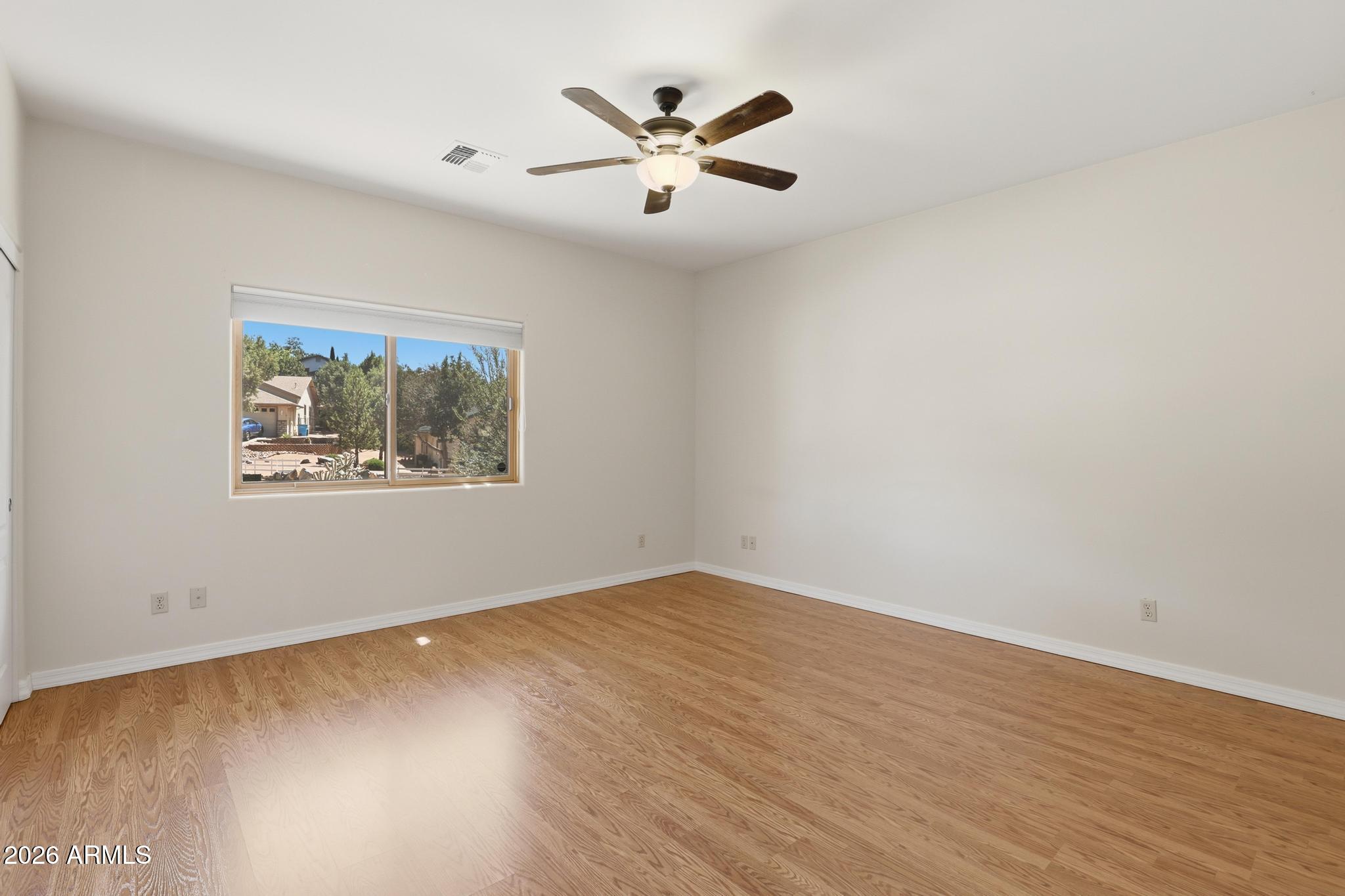 408 East Phoenix Street Payson, AZ 85541 - Photo 15 of 35 an empty room with wooden floor and ceiling fan