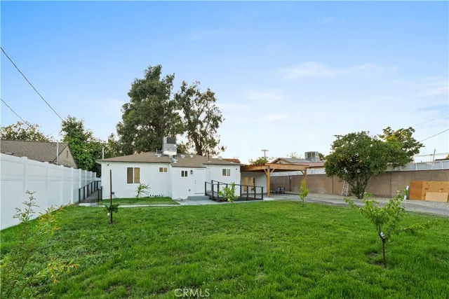 a view of house with backyard
