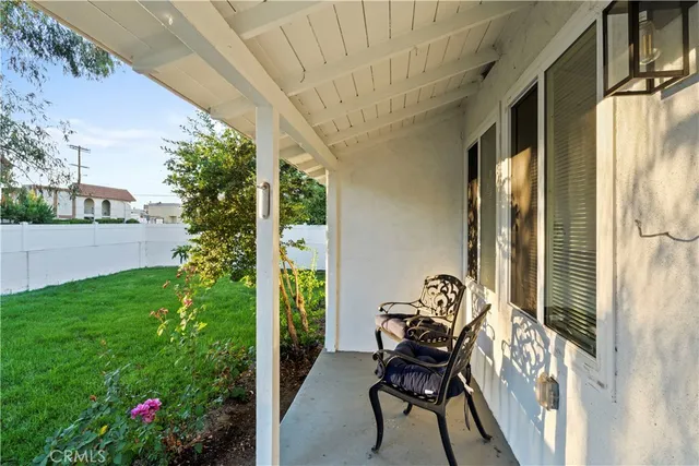 a view of a porch with furniture and garden