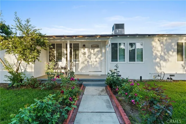 a front view of a house with a garden