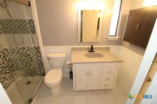 a bathroom with a sink toilet and shower