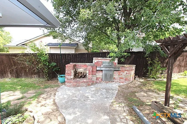 a view of backyard with swimming pool and green space