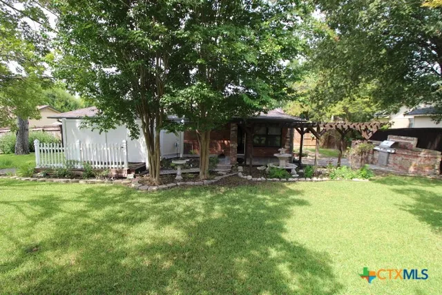 a view of a porch with furniture and garden