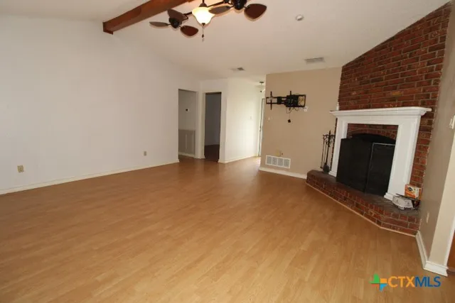 an empty room with a fireplace