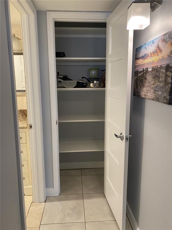 5555 Gulf Boulevard, Unit 104 St. Pete Beach, FL 33706 - Photo 14 of 35 a view of a closet with wooden floor