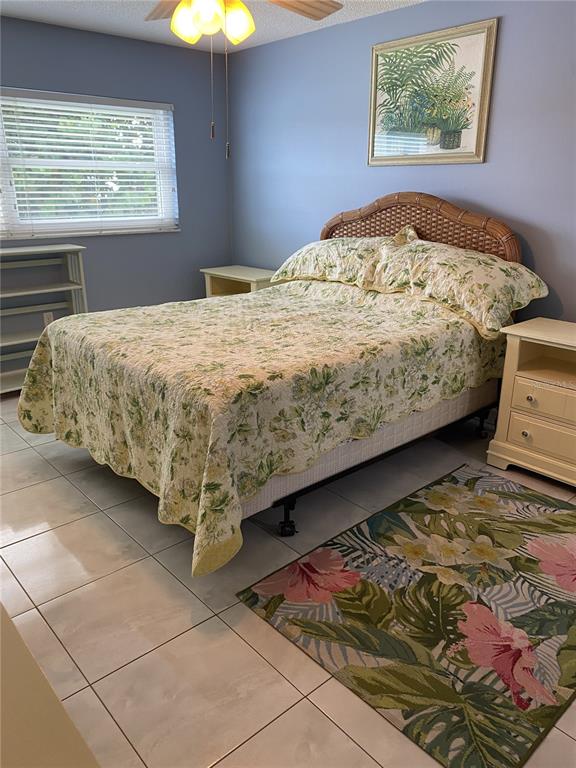 5555 Gulf Boulevard, Unit 104 St. Pete Beach, FL 33706 - Photo 16 of 35 a bed sitting in a bedroom next to a window