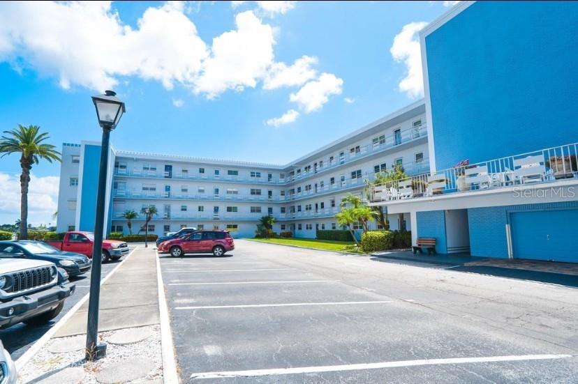 5555 Gulf Boulevard, Unit 104 St. Pete Beach, FL 33706 - Photo 19 of 35 a cars parked in front of a building