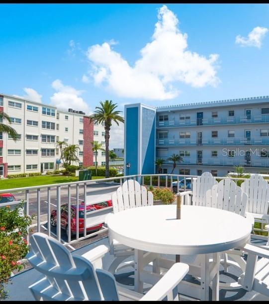 5555 Gulf Boulevard, Unit 104 St. Pete Beach, FL 33706 - Photo 21 of 35 a view of a swimming pool with a patio