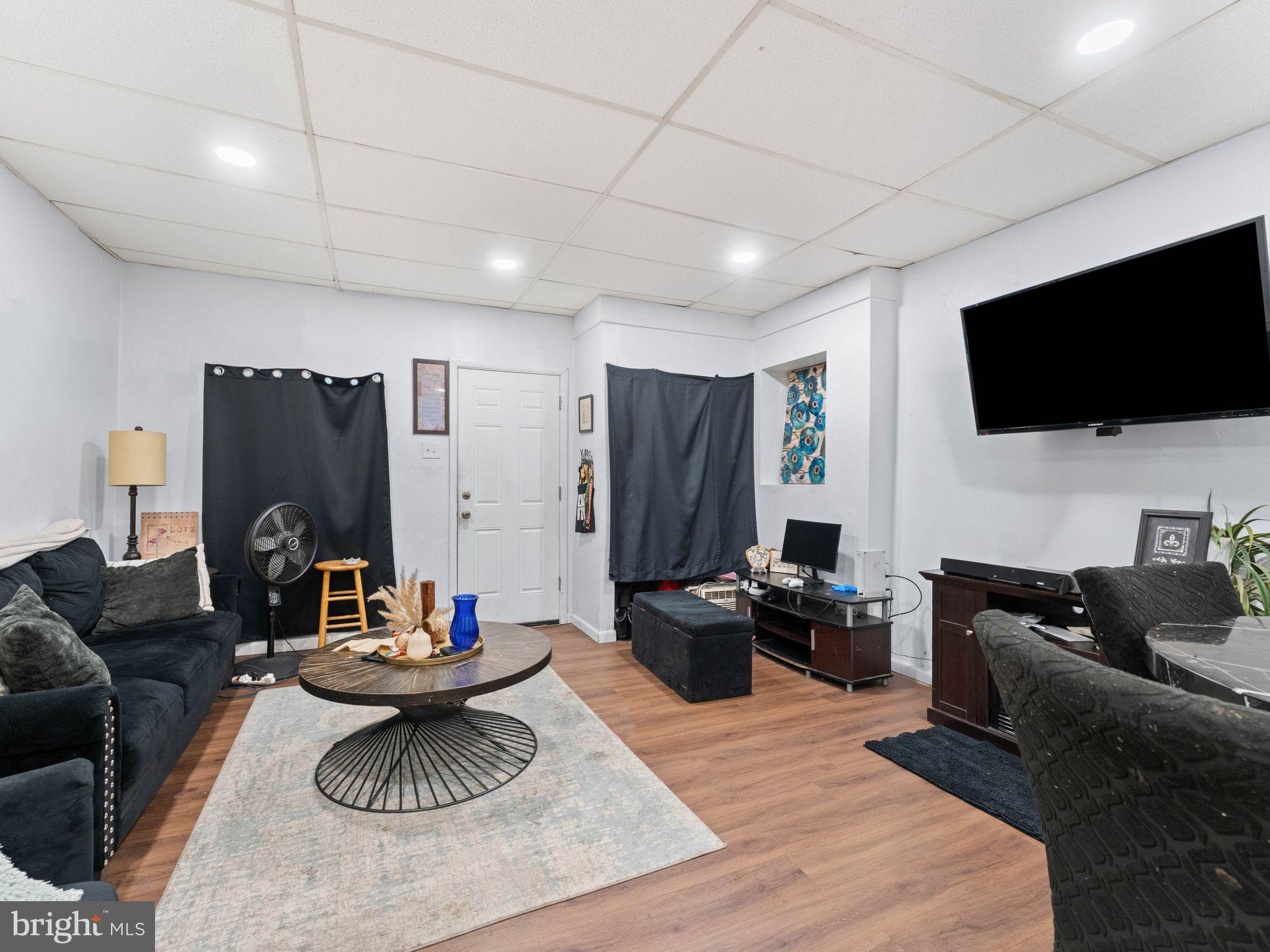 400 Market Street Marcus Hook, PA 19061 - Photo 10 of 25 a living room with furniture a flat screen tv and kitchen view