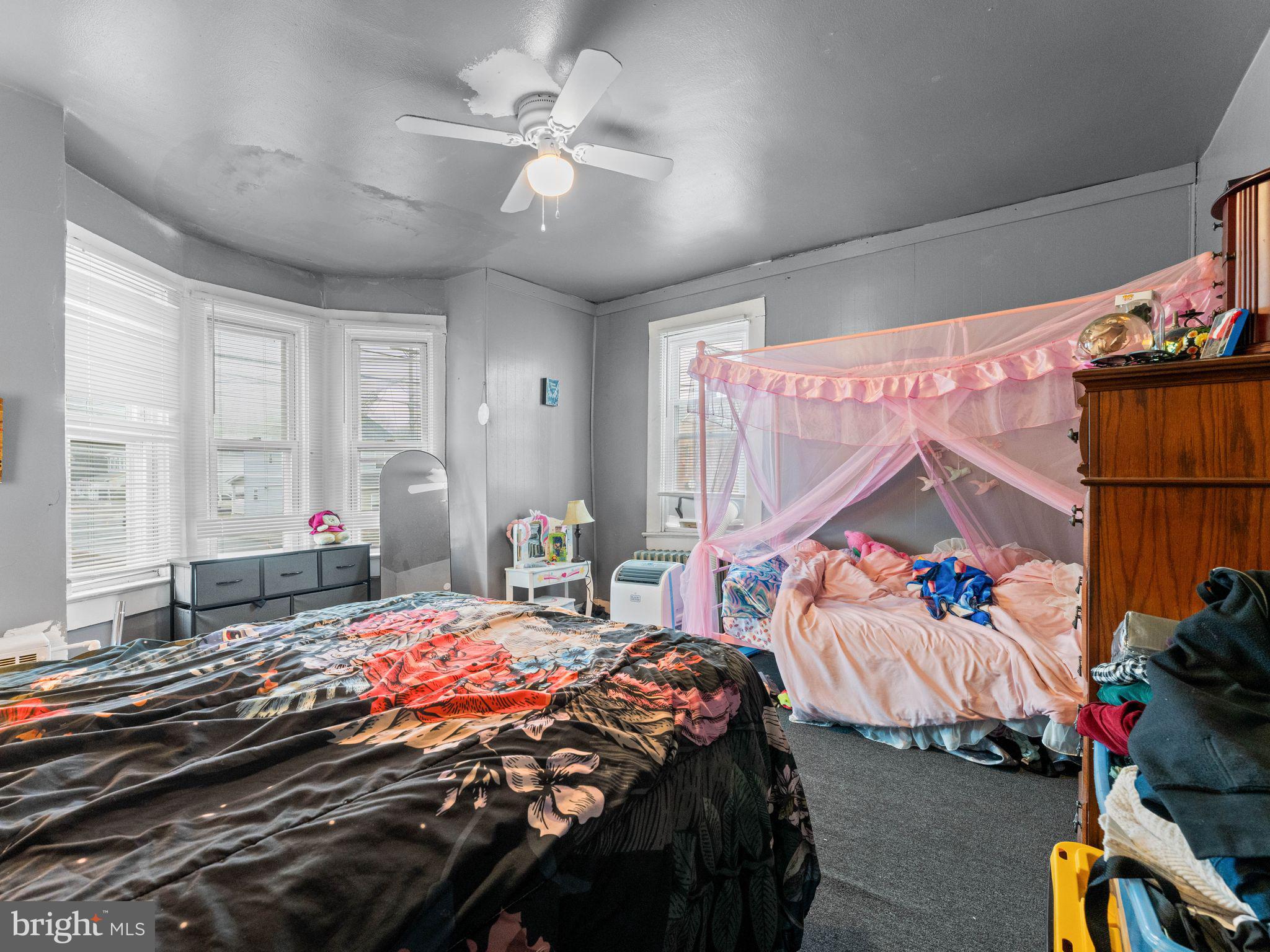 400 Market Street Marcus Hook, PA 19061 - Photo 17 of 25 a bedroom with a bed and a chandelier