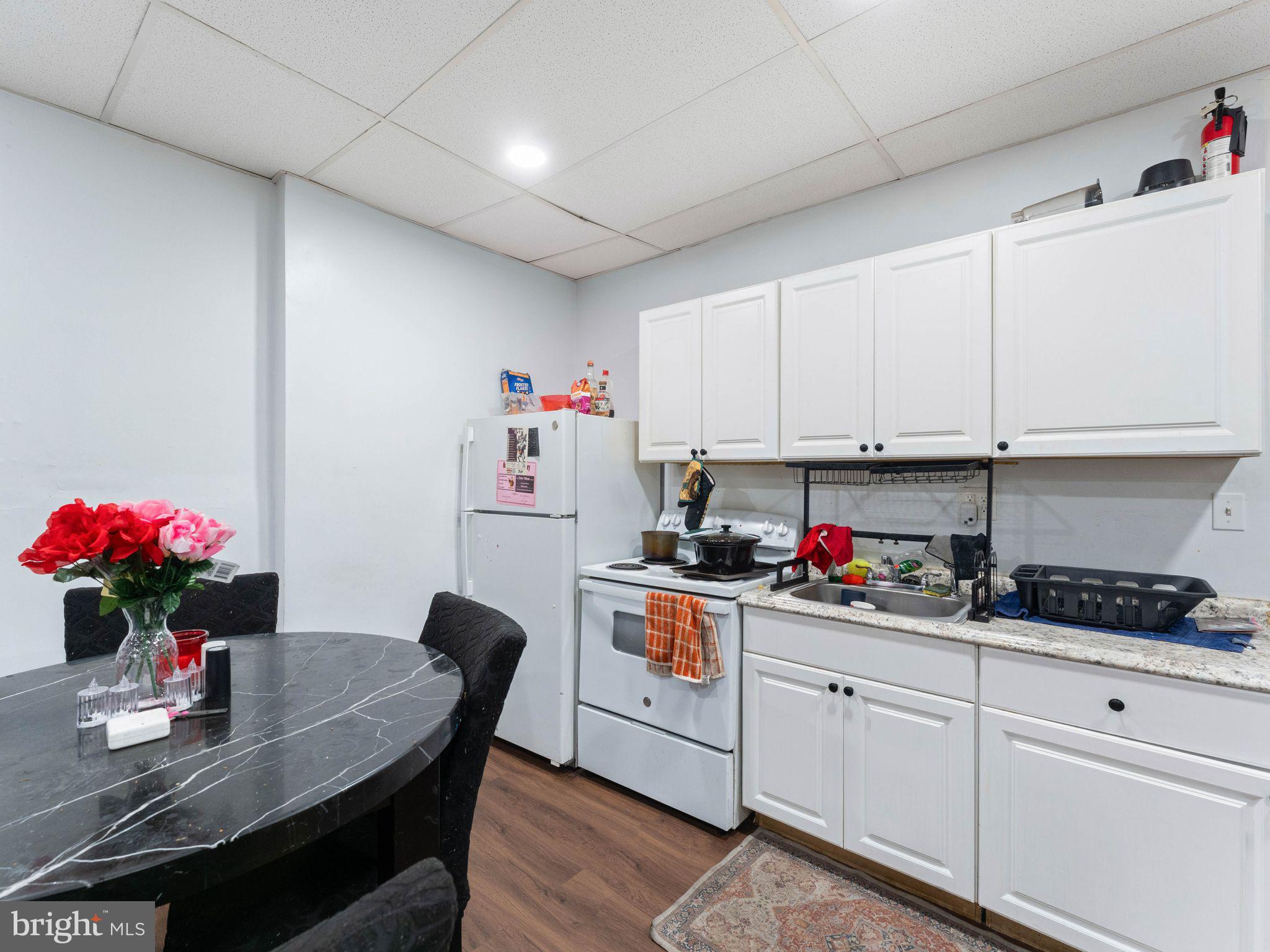 400 Market Street Marcus Hook, PA 19061 - Photo 3 of 25 a kitchen with stainless steel appliances granite countertop a sink dishwasher and white cabinets with wooden floor
