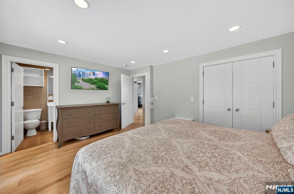 57 Hemlock Road Little Falls, NJ 07424 - Photo 27 of 50 a bedroom with a bed and a flat screen tv