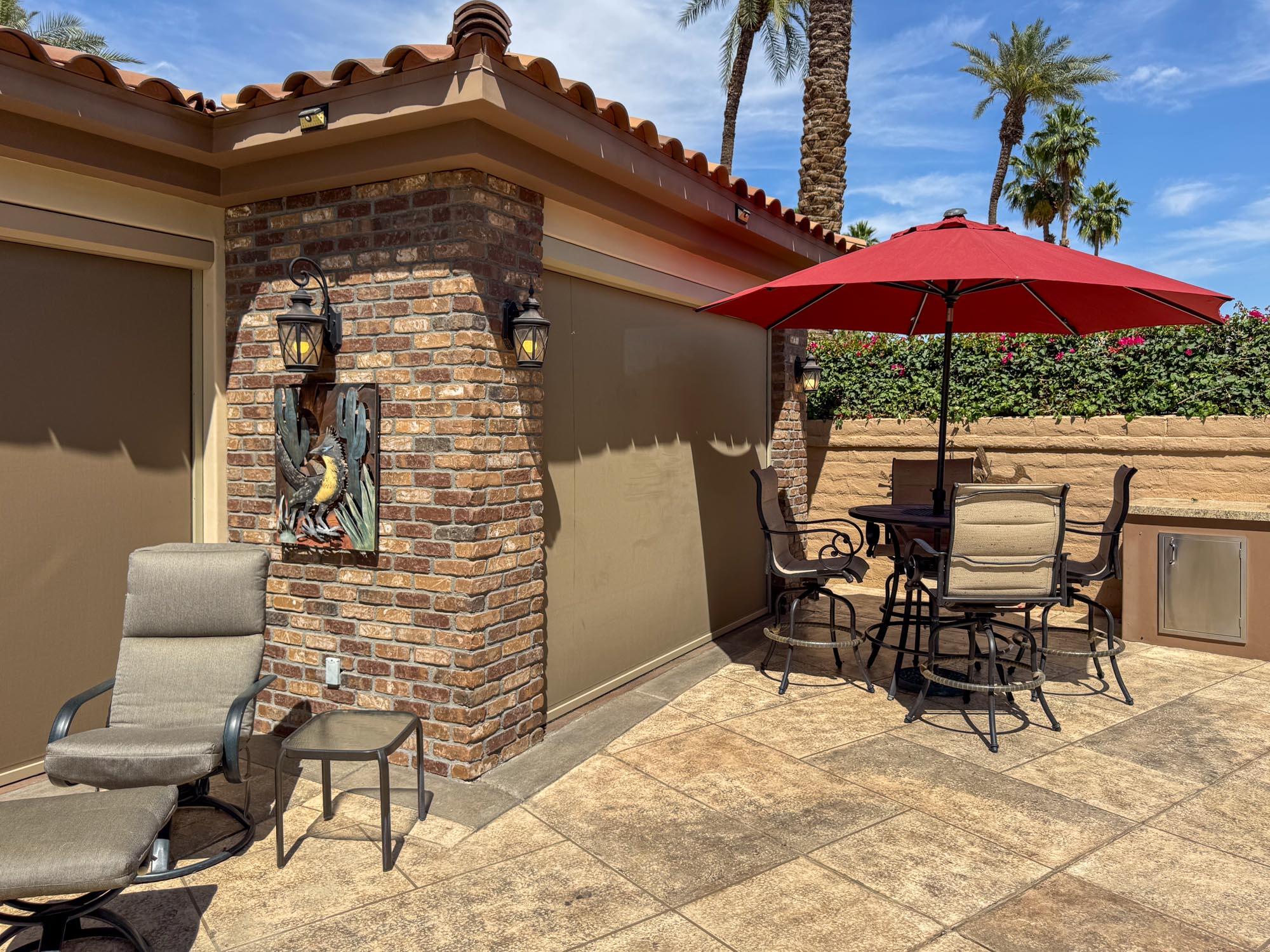 80394 Ave 48, Unit 116 Indio, CA 92201 - Photo 16 of 26 a patio with a table and chairs under an umbrella