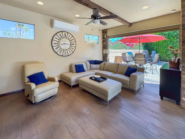 a kitchen with stainless steel appliances granite countertop a stove top oven and a wooden floor