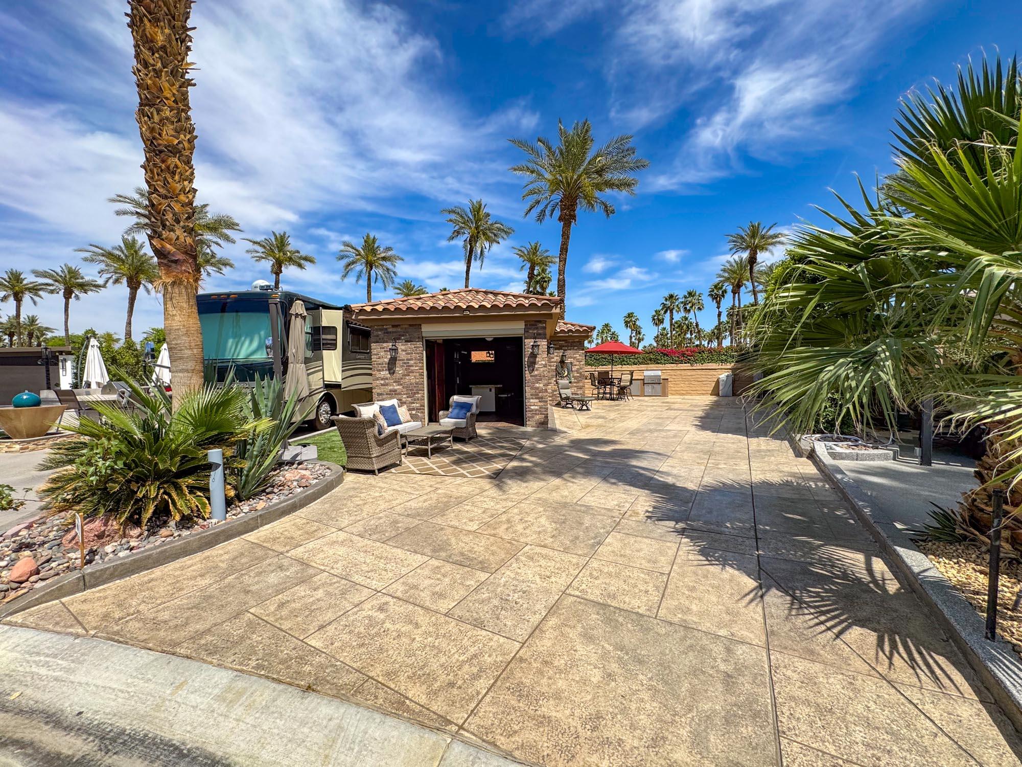 80394 Ave 48, Unit 116 Indio, CA 92201 - Photo 26 of 26 a view of a house with potted plants and palm trees