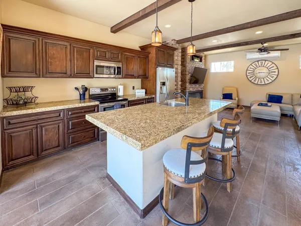 a kitchen with stainless steel appliances granite countertop a stove and a sink