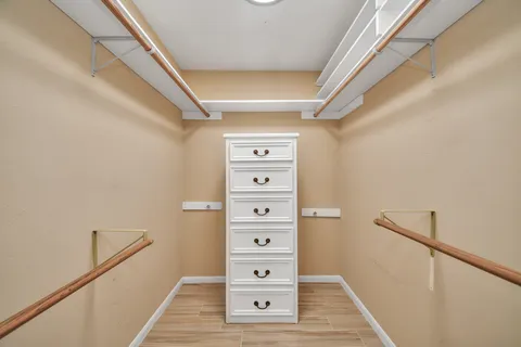 an empty room with windows and view of ceiling fan