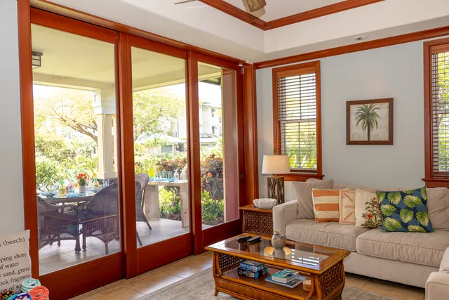 a living room with furniture and a floor to ceiling window